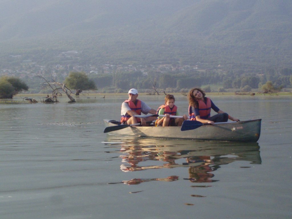 boat on lake with three people